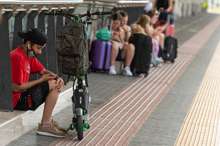 Pisa, Italy - August 10, 2021: people are waiting for a train at the train station on the platform