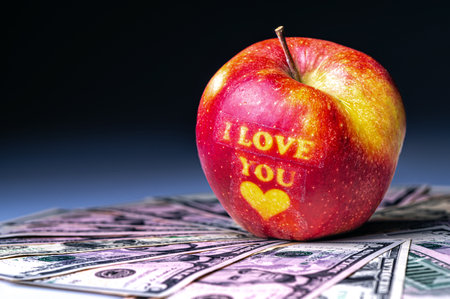 I love You apple with heart on dollar banknotes. The concept of love and prosperity. Close-up