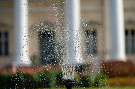 fountain splash closeup on a defocused background of an old manor, selective focusの写真素材