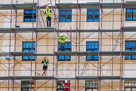Riga, Latvia - September 30, 2020: construction workers in scaffolding on the building facade for restore, repair and renovateのeditorial素材