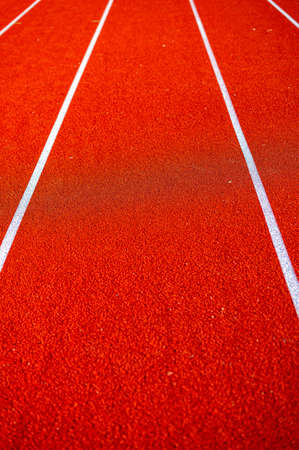 red runninng race track with border lanes, treadmill at stadium, sport and fitness concept, close-upの写真素材