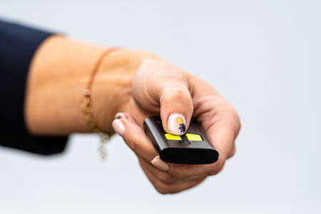 woman hand holding the car remote, he push the remote control to open the car doorの写真素材