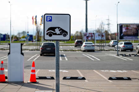 Riga, Latvia, April 29, 2022: road sign, electric car parking place at the charging station in the public parking lot of the supermarketのeditorial素材