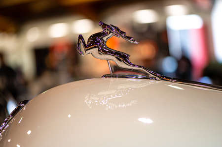 Riga, Latvia, April 29, 2022: Running deer - the brand logo of the automaker GAZ on bonnet of car Gaz 21 Volga, closeupのeditorial素材