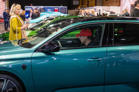 Riga, Latvia, April 29, 2022: people get acquainted with the new family car Peugeot 308 sw