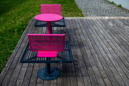 colorful metal benches and tables on the terrace on a sunny dayの写真素材