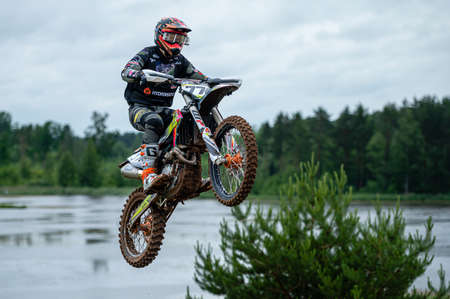 Dobele, Latvia, June 18, 2022: the racer on motocross in flight, jumps and takes off on a...