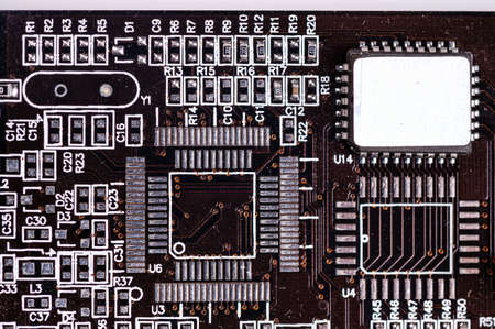 macro close-up shot of microchip on black printed circuit board, computer vide ocard with components