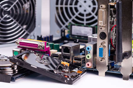fragment of computer circuit board with components on the background of defocused power supply fansの写真素材