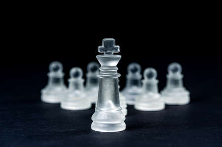 transparent glass chess on black background, selective focus on king piece, close-upの写真素材