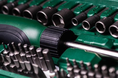 Interchangeable screwdriver set with different types of metal steel heads and bits, selective focus