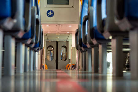 Italian railroad train interior, seats in a train in a row, train carriage with blue seats
