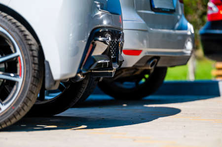 close-up of the wheels and bumpers of a car parked in the yard of a residential house, lower sectionの写真素材