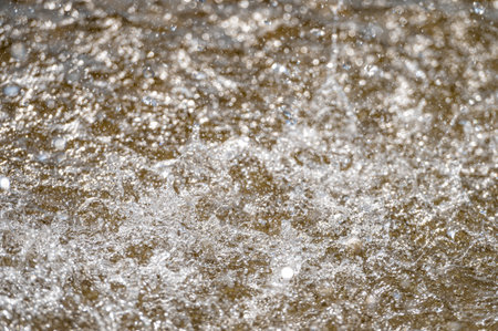 Water splash with small drops in the fountain. Abstract natural, selective focus backgroundの写真素材