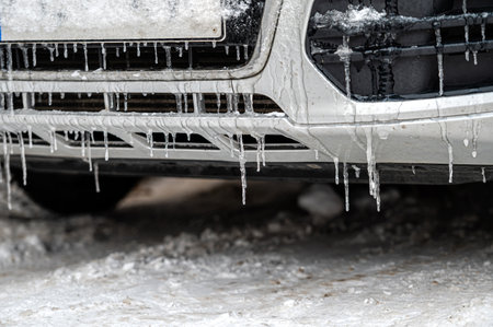 Ice-covered car bumper with icicles close-up, Icicles on the bumper of the car in winterの写真素材