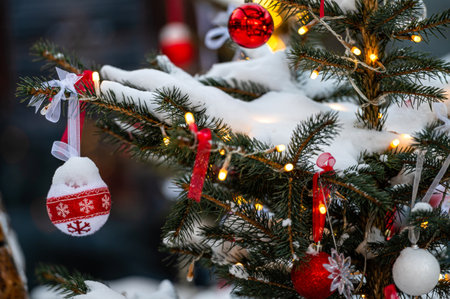 Christmas toys on the Christmas tree. Snow on a branch. Street decoration in winter.の写真素材