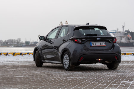 Riga, Latvia - February 9, 2021: metallic grayToyota Yaris Hybrid Y20 Edition Hatchback car parked on the seafrontのeditorial素材
