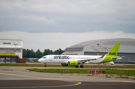 Riga, Latvia - August 31, 2021: AirBaltic Airbus A220-300 YL-AAS landing/arrival in Riga/RIX/EVRA airport on cloudy autumn dayのeditorial素材