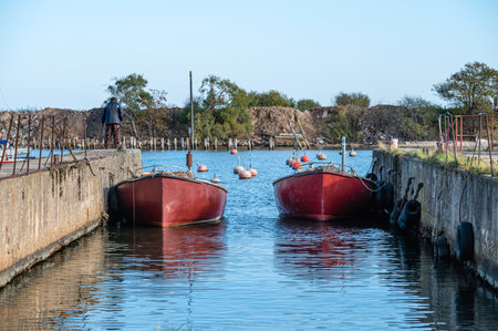 fishing boats docked in the harbor channel, Engure, Latviaの写真素材