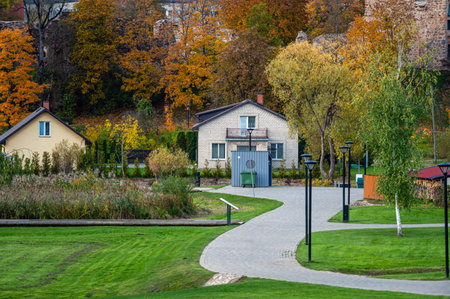a park with paved walkways in a small town on an autumn dayの写真素材