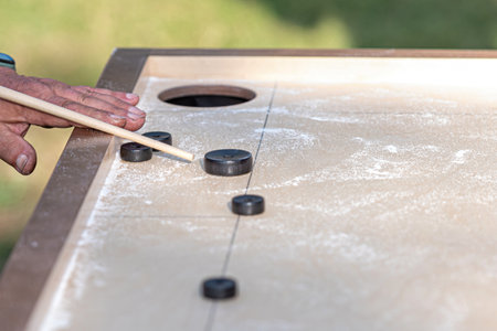 Men playing Novuss game. Novuss is a national sport in Latvia similar to pocket billiards or pool.