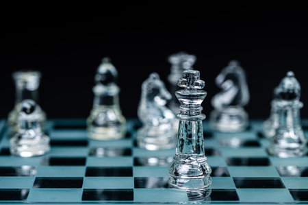 glass chess board game in black background ,selective focus on King, leadership ,winner conceptの写真素材