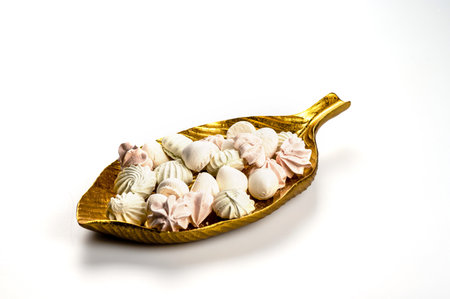 decorative dish with meringue cookies from egg whites, selective focus, close-up, copy spaceの写真素材