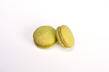 macarons, confectionery sweet product, two green macarons isolated on white backgroundの写真素材