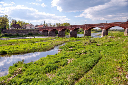 The old red brick bridge across the Venta river, road bridge, built in 1874, Kuldiga, Latviaの写真素材