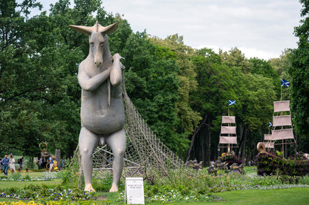 Pakruojis, Lithuania. July 1, 2023: Flower festival in Pakruojis manor. An anthropomorphic donkey sculpture and flowers in manor park.のeditorial素材