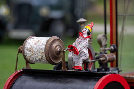 Pakruojis, Lithuania. July 1, 2023: Old popcorn machine decoration - a clown spins a transparent barrel with popcornのeditorial素材