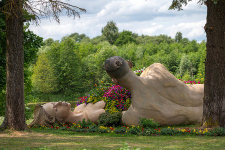 Pakruojis, Lithuania. July 1, 2023: Flower festival in Pakruojis manor. Sculptures of lovers with a blanket of flowers.のeditorial素材