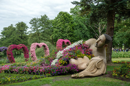 Pakruojis, Lithuania. July 1, 2023: Flower festival in Pakruojis manor. Sculptures of lovers with a blanket of flowers.のeditorial素材