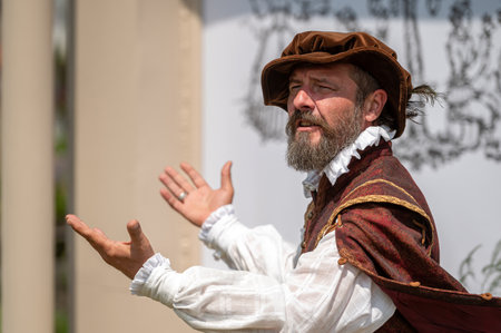 Pakruojis, Lithuania. July 1, 2023: An animator in medieval costume entertains tourists by telling...