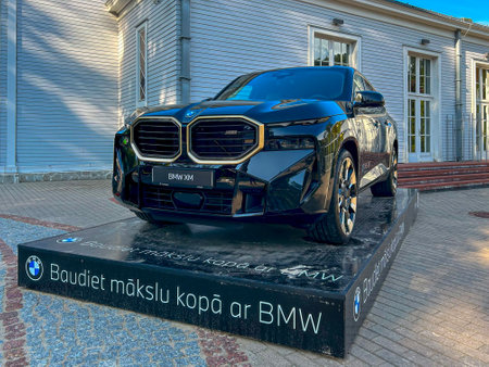 Jurmala, Latvia - September 2, 2023:  The new BMW XM is displayed on the street near the Dzintari concert hall. Inscription on the pedestal in Latvian "Enjoy art with BMW"のeditorial素材