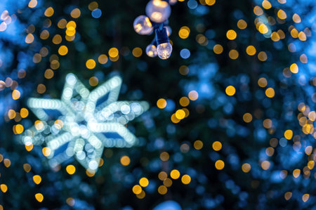 garland of light bulbs on defocused christmas lights background, shallow depth of field, copy space