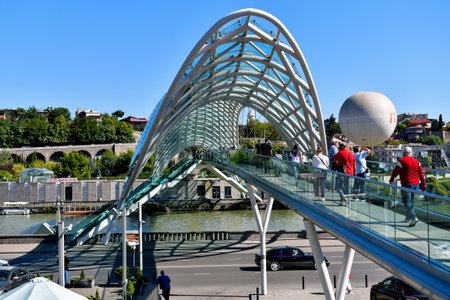Tbilisi, Georgia - October 8, 2023: Pedestrian bow-shaped Bridge of Peace over the Kura Riverのeditorial素材