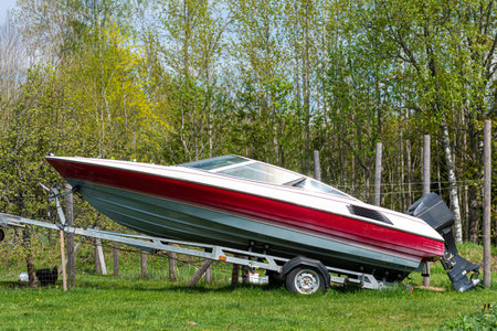 A motorboat on a transport trailer in a green meadowの写真素材