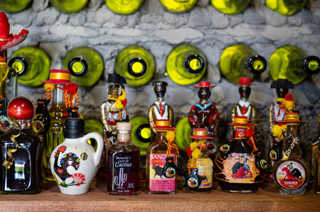 Litene, Latvia - May 25. 2023: A collection of different alcoholic beverages bottles on the shelf in the cellar.のeditorial素材