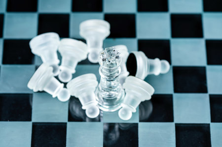 glass chess board game in black background ,selective focus on King, leadership ,winner conceptの写真素材