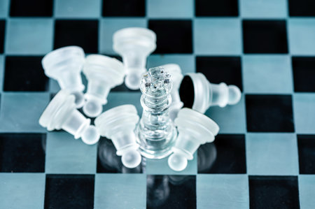 glass chess board game in black background ,selective focus on King, leadership ,winner concept