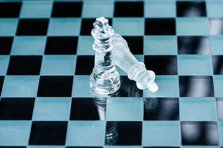 transparent glass chess on dark background, selective focus on king piece, close-up
