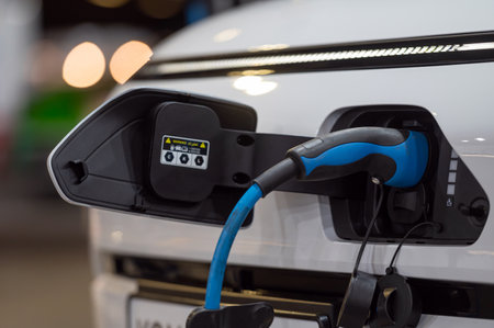 Electric car connected to the charger, eco friendly technology, close-up