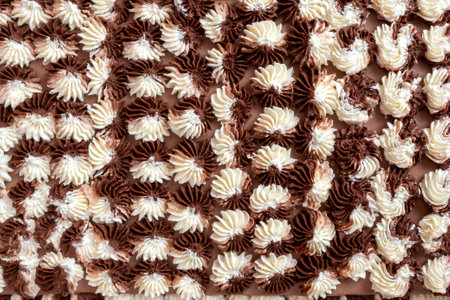 Close-up of a chocolate cake frosted with swirls of chocolate and vanilla frosting.の写真素材