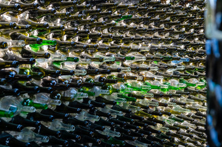 Wine bottles in a row on a stone wall.  Abstract decorative glass bottle backgroud pattern. Close-upの写真素材