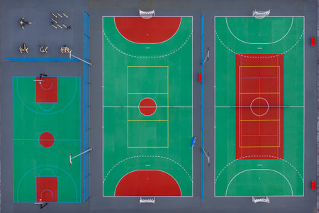 Aerial view of vibrant multi-sport courts in urban area with basketball and tennis sectionsの写真素材