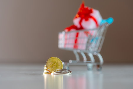 Golden Coins in Foreground With Shopping Cart Full of Gifts in Backgroundの写真素材