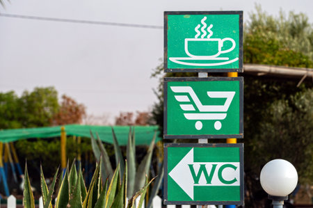 Signs guide visitors to enjoy coffee, shop, or find restrooms in Essaouira, Morocco.