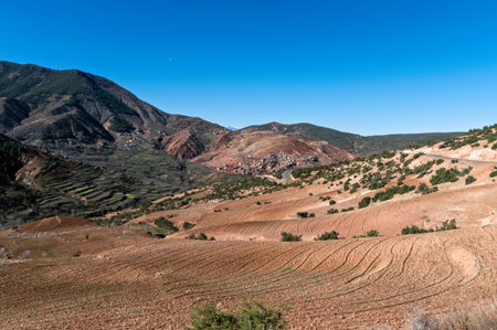 Discover Morocco's Atlas Mountains with terraced fields and clear blue skies.の写真素材