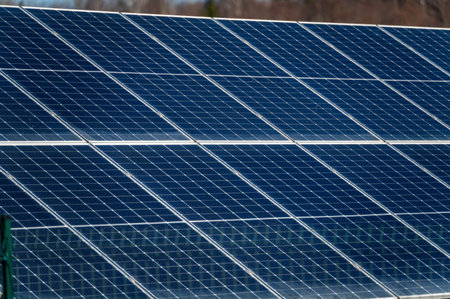 Large solar panels are positioned to absorb sunlight in a renewable energy facility.の写真素材